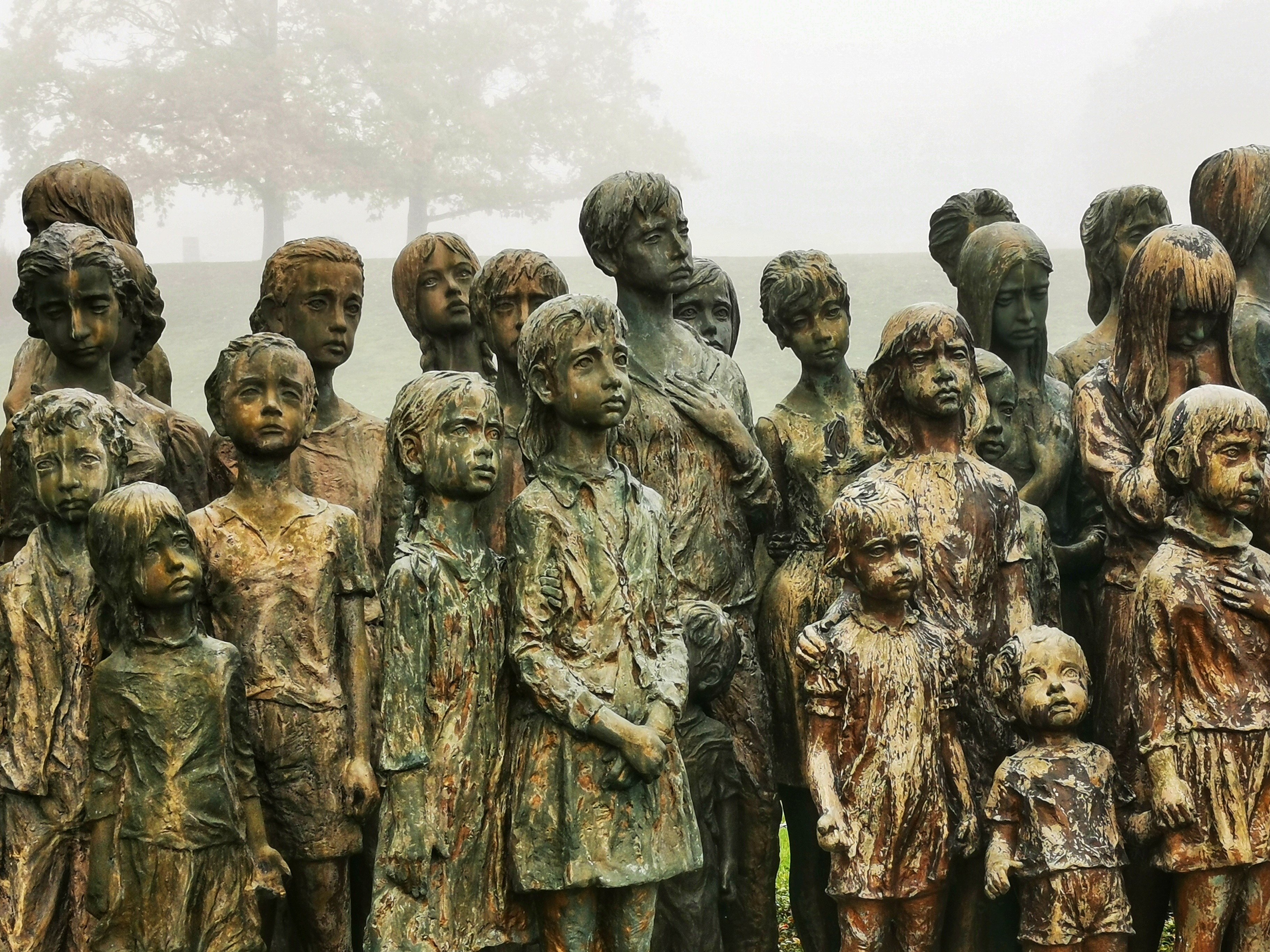 Therefore, she cast in bronze the first three statues from her own savings. Unfortunately, in autumn 1989 she unexpectedly died of a heart attack. She could only see her whole life work placed in Lidice in her imagination. Her husband J. V. Hampl continued in the work since 1990 on his own. The last 7 statues were uncovered in 2000.